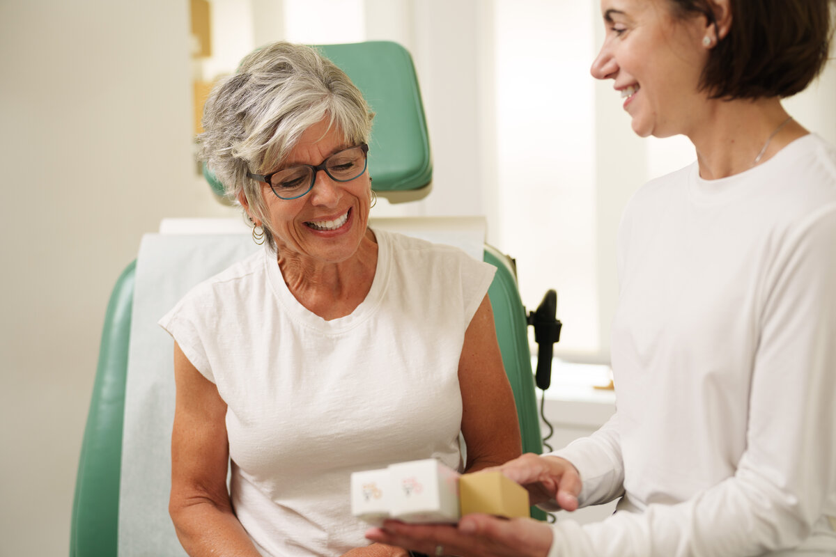 Patient receiving skincare products from staff